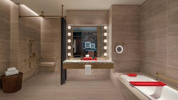A modern bathroom with a vanity, a bathtub, and a large mirror with lights.