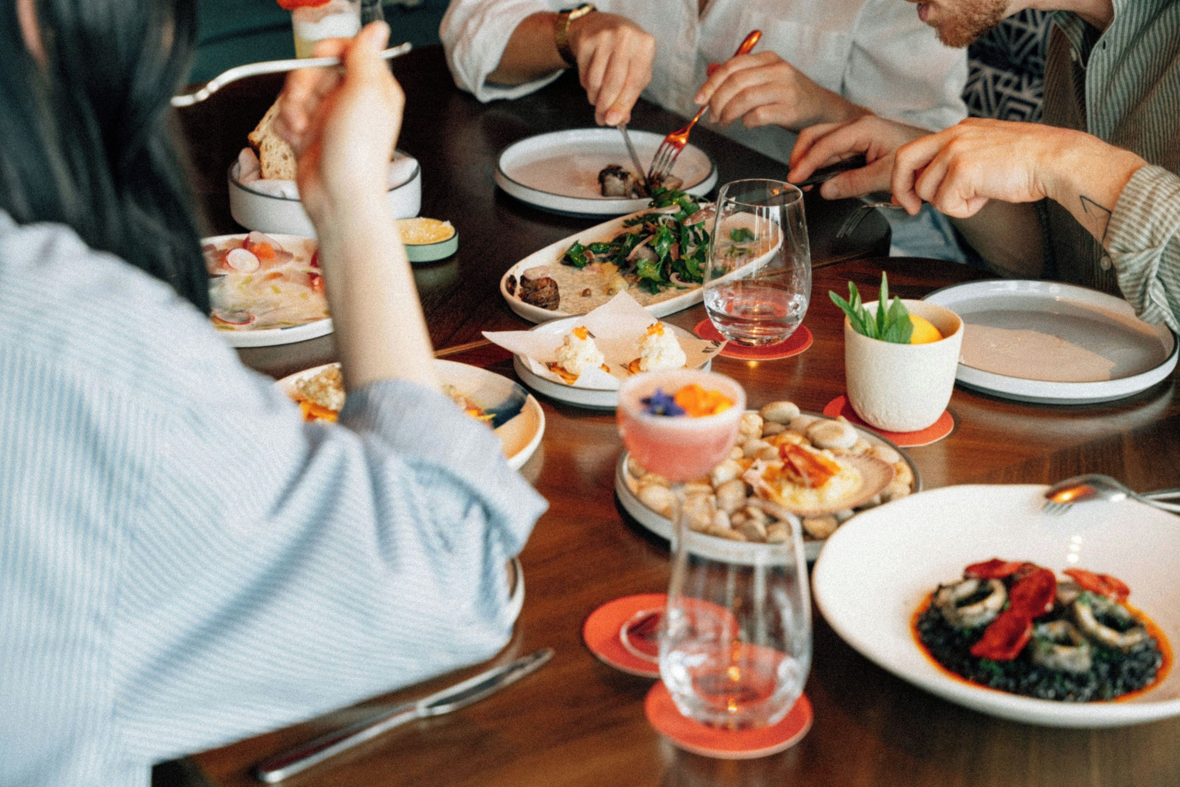 A dining table with various dishes and a glass of water.