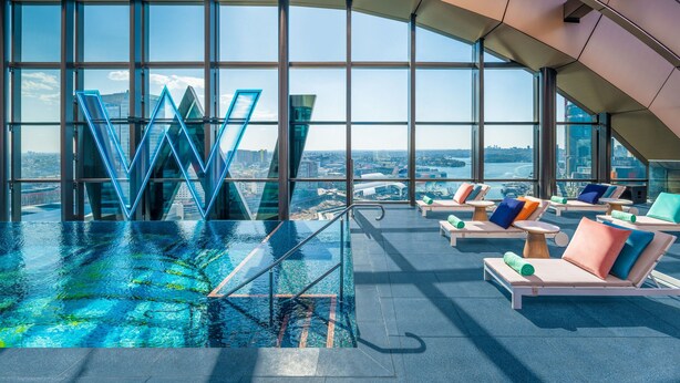 A rooftop infinity pool with lounge chairs and a view of the cityscape. - W Sydney (Sydney)