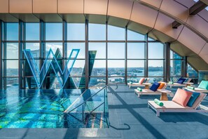 A rooftop infinity pool with lounge chairs and a view of the cityscape. - W Sydney (Sydney)