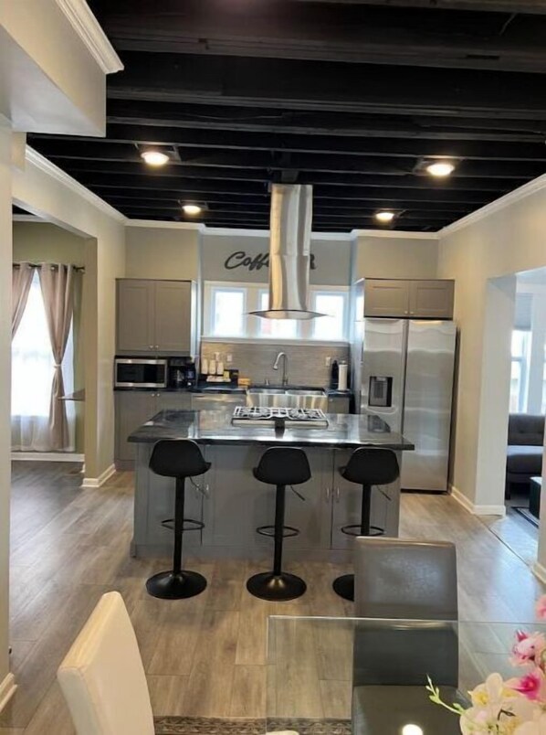 Enjoy cooking in this well-equipped kitchen with a central island and bar stools.