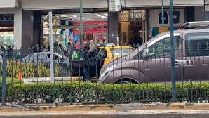 A multi-story hotel with balconies, a visible storefront below, and a street with parked cars and bicycles. - Hotel Dorado (Guayaquil)