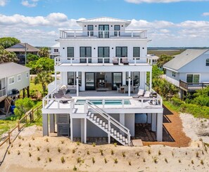 A multi-story beachfront house with a pool, a covered outdoor area, and a staircase leading to a lower level. - 1713 East Ashley! Luxurious Home, Private Oceanfront Pool (Folly Beach)