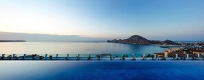 Enjoy a serene ocean view with a tranquil pool and Mediterranean-style architecture.