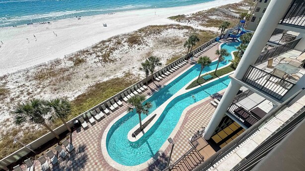 A resort with a pool, beach, and ocean view.