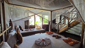 A room with a bed, a fan, and a staircase. - Salama & Mbuyuni Bungalows (Matemwe)