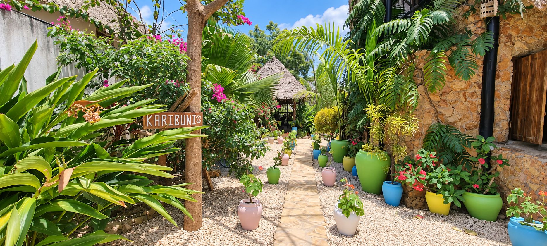 A garden pathway leading to a thatched-roof structure, surrounded by various potted plants and greenery.