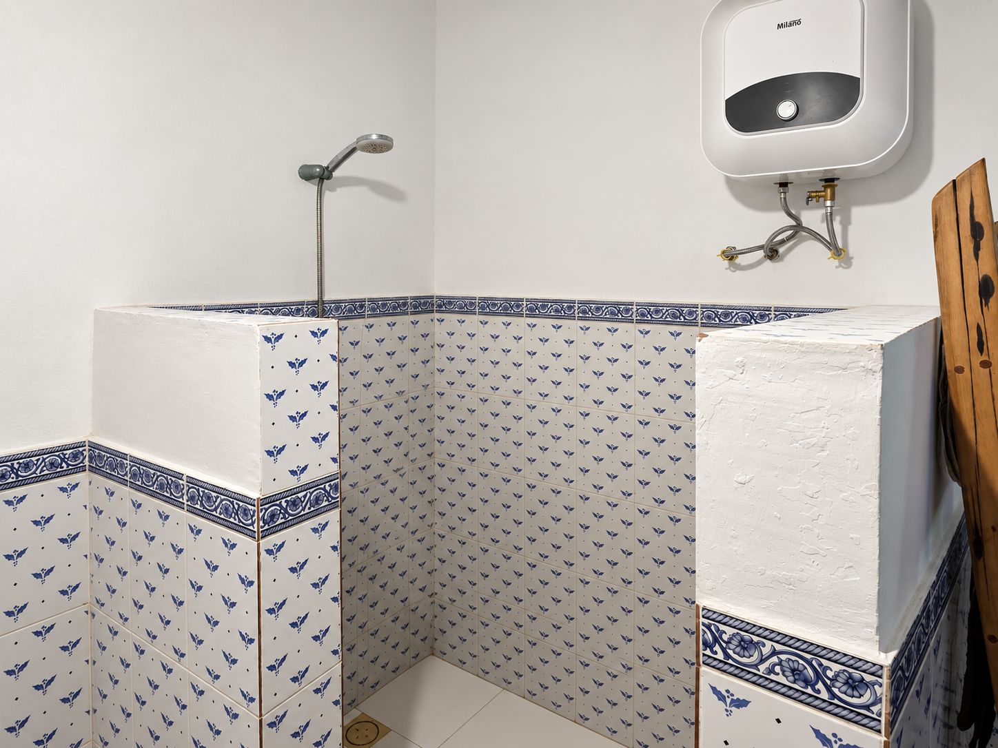 A bathroom with a shower, a toilet, and a sink.