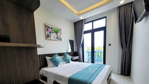 A hotel room with a bed, a bedside table with a tray of items, a window with curtains, and a balcony view. - E3 Homestay & Cafe Phu Quoc (Phu Quoc)