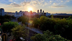 A cityscape with a prominent building featuring a dome and spire, surrounded by lush greenery and a clear sky. - E3 Homestay & Cafe Phu Quoc (Phu Quoc)