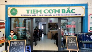 A storefront with a sign reading "TIEM COM BÃC" and a menu board outside. - E3 Homestay & Cafe Phu Quoc (Phu Quoc)