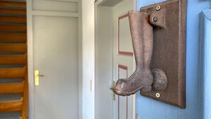 A door with a metal kick plate and a wooden staircase to the left. - Holiday Home 'Altes Rathaus' with Terrace & Wi-Fi (Leibertingen)