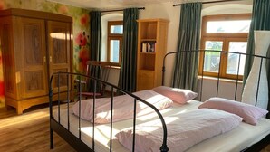 A single bed with a metal frame, wooden wardrobe, and a chair. - Holiday Home 'Altes Rathaus' with Terrace & Wi-Fi (Leibertingen)
