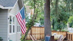 Eine Terrasse mit Holzbänken, einem Tisch und einer US-amerikanischen Flagge.