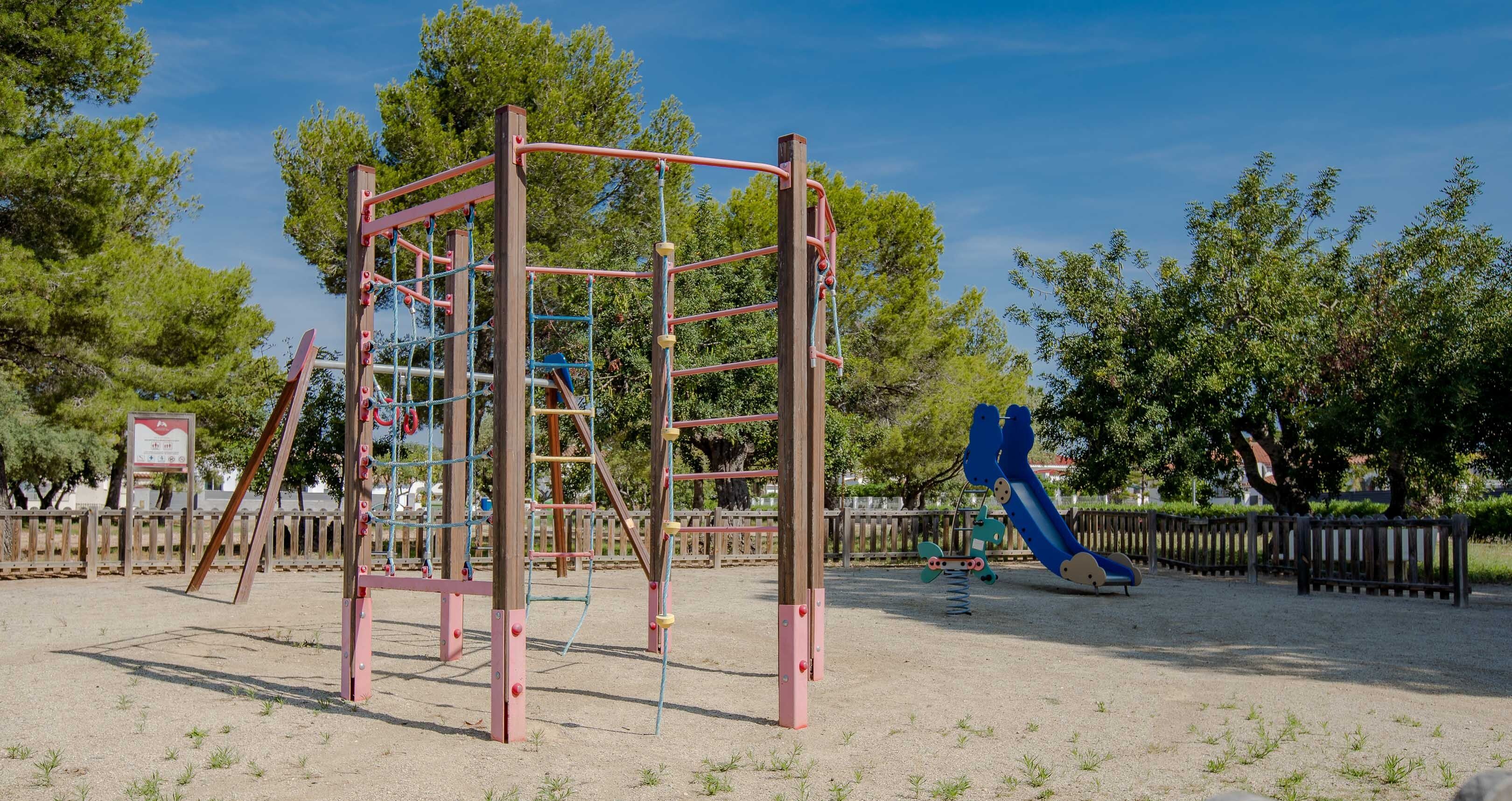 A playground with a climbing structure and a slide.