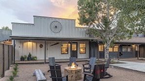 A modern building with a fire pit and outdoor seating. - Hotel Palomino (Ridgway)