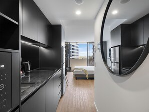 Deluxe King Studio | Private kitchenette | Fridge, microwave, electric kettle, cookware/dishes/utensils