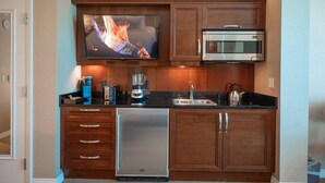 A compact kitchen with a built-in microwave, a coffee maker, a toaster, and a refrigerator. - *No Resort Fee*MGM StripView*Jacuzzi*F1 Trackview* (Las Vegas)