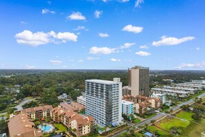 A high-rise hotel with multiple floors, surrounded by other buildings and a clear sky. - Oceanview, Pools, Hot tub, Indoor pool, 2 Beds (Myrtle Beach)