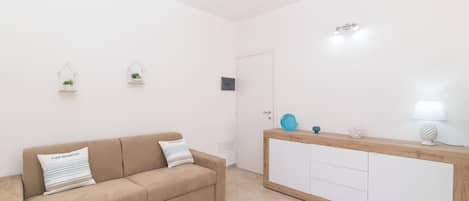 Departamento familiar, varias habitaciones (Appartamento Rosmarino In The City) | Área de sala de estar | Televisión de pantalla plana de 21 pulgadas con canales por cable
