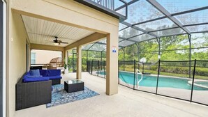 An outdoor covered area with a pool, seating, and a ceiling fan. - Beautiful Family Getaway Davenport Florida (Davenport)