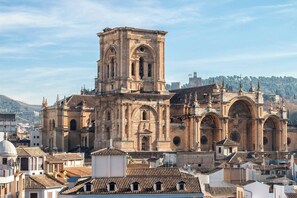 Una cattedrale storica con un campanile imponente, ampie arcate e elaborate decorazioni in pietra.