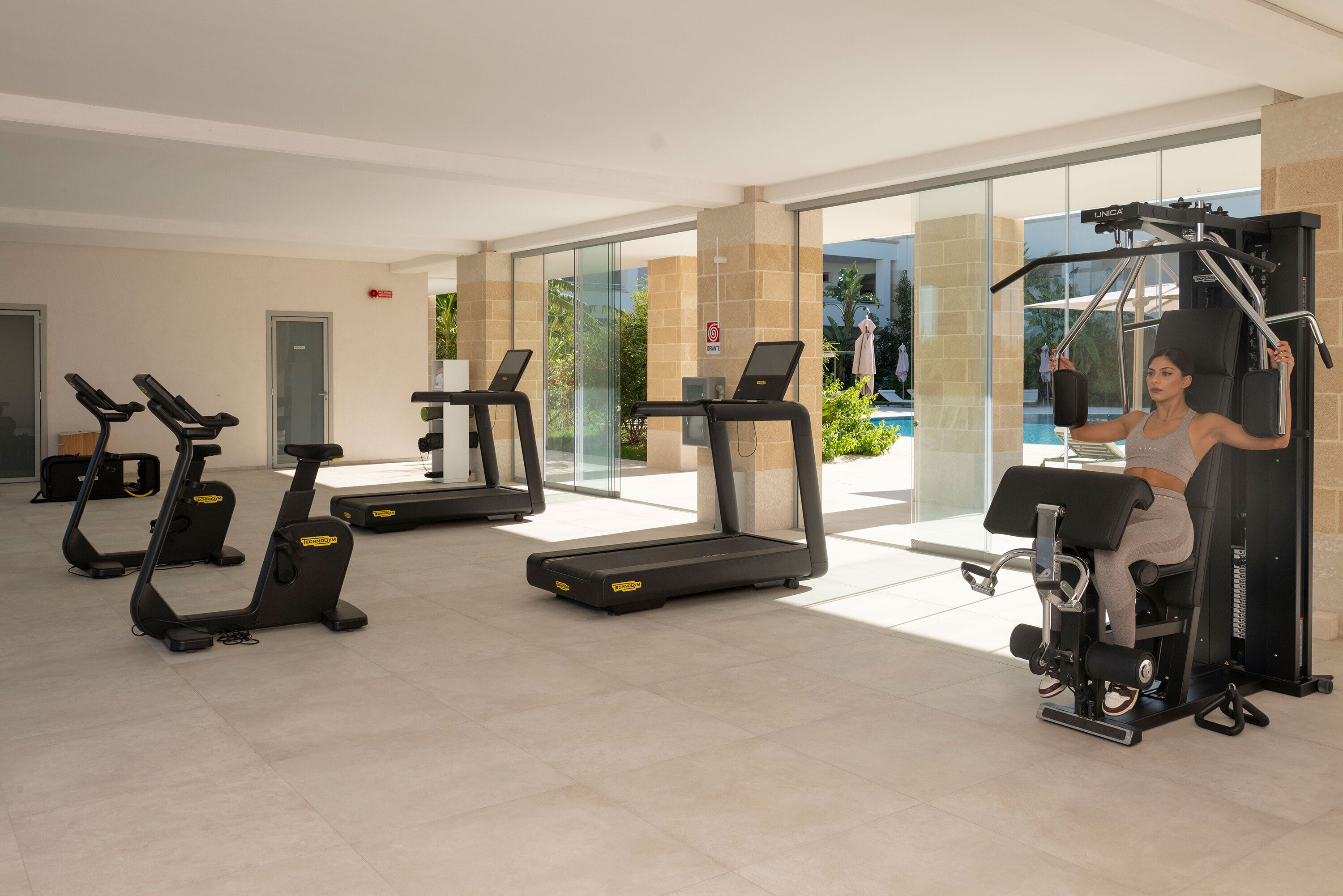 A gym with treadmills, a stationary bike, and a weight machine.