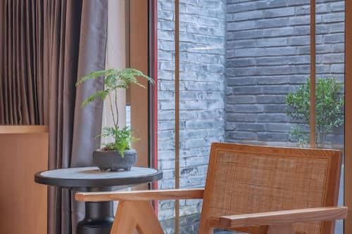 Deluxe Double Room With Private Patio | Living area | Heated floors, computer monitors, printers