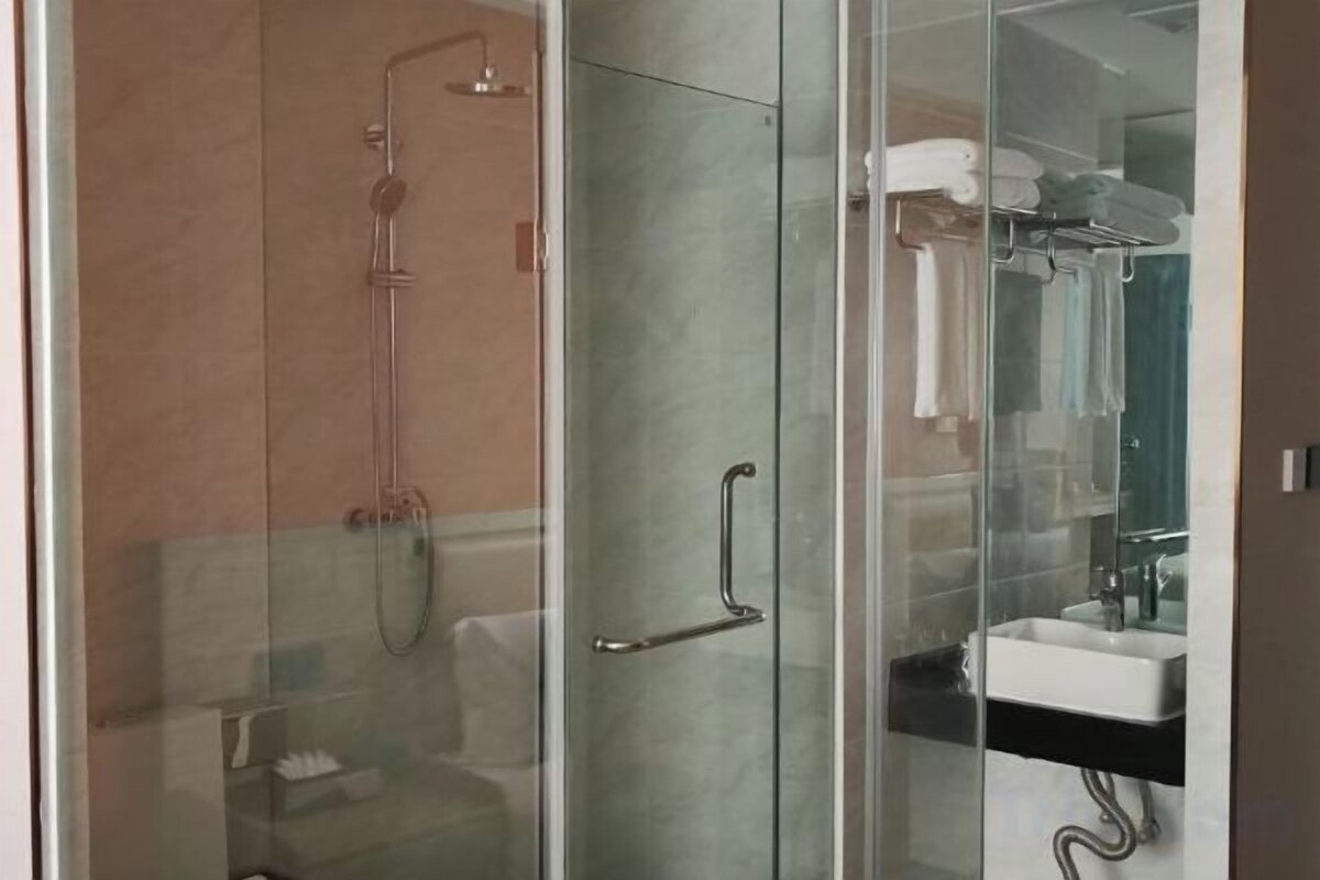 Shower, rainfall showerhead, hair dryer (on request), slippers