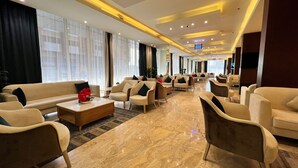 A spacious lobby with multiple seating areas, a marble floor, and large windows with sheer curtains. - Paradise Inn Jeddah (Jeddah)
