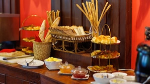 Una mesa de buffet con diversos alimentos y cubiertos.