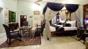 A traditional room with a four-poster bed, a chandelier, and a patterned rug. - Hari Mahal Palace-By Pachar Group (Jaipur)