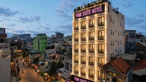 A multi-story hotel with balconies and a sign reading 'Pink Suite Hotel.' - Pink Suite Saigon Airport Hotel (Ho Chi Minh City)