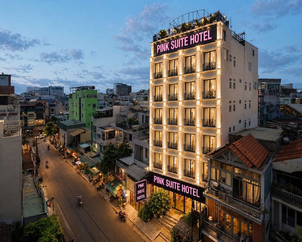 A multi-story hotel with balconies and a sign reading 'Pink Suite Hotel.' - Pink Suite Saigon Airport Hotel (Ho Chi Minh City)