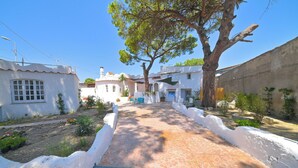 A paved pathway leading to a building with white walls and a tiled roof. - Villa Aida Luxury Apartments & Spa (Forio)