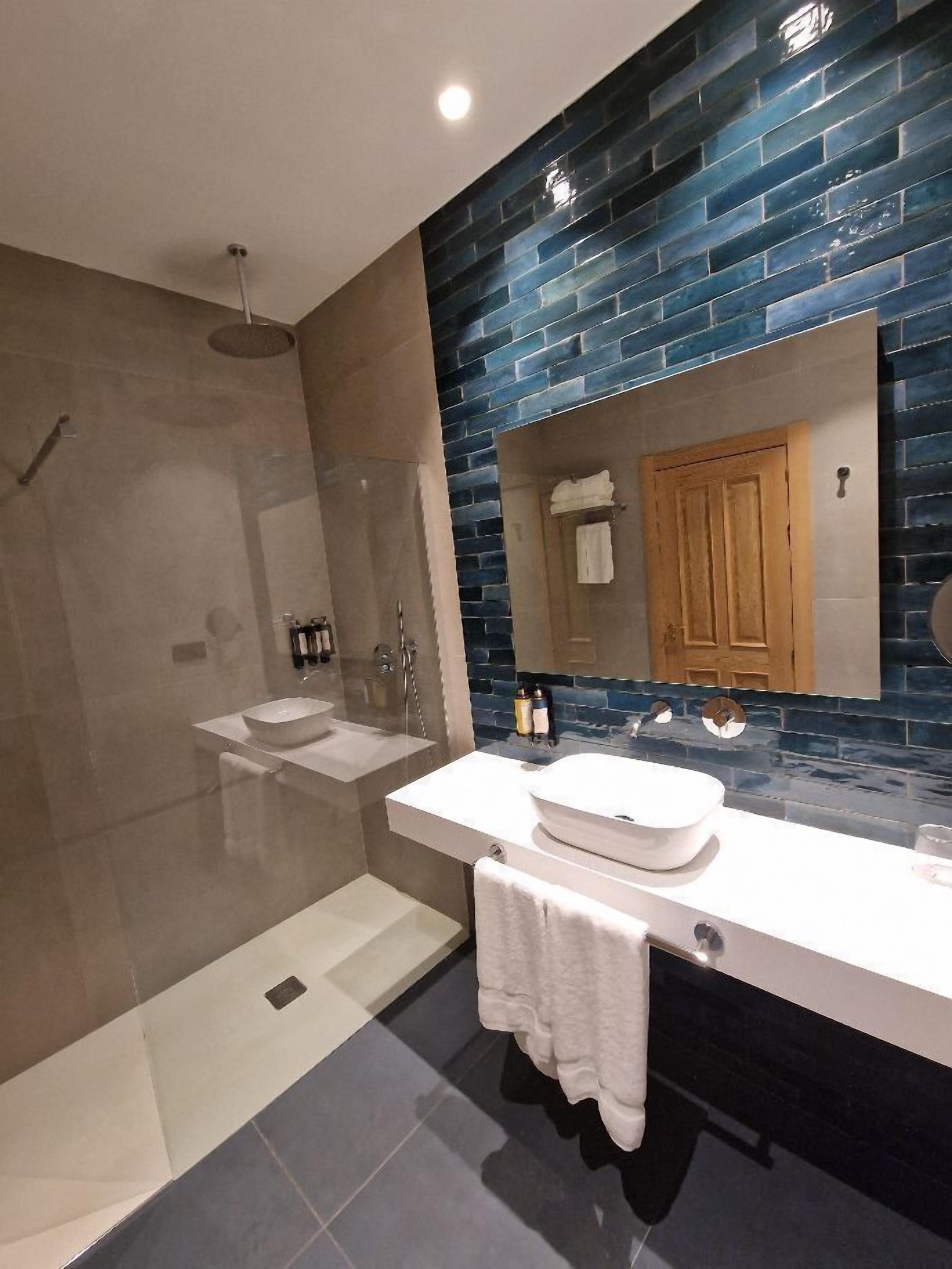 superior double room | bathroom | shower, rainfall showerhead, hair dryer, towels
