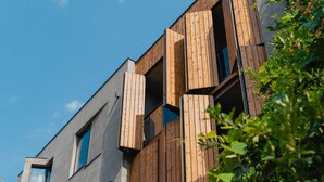 A modern building with wooden paneling and large windows. - About Sololaki (Tbilisi)