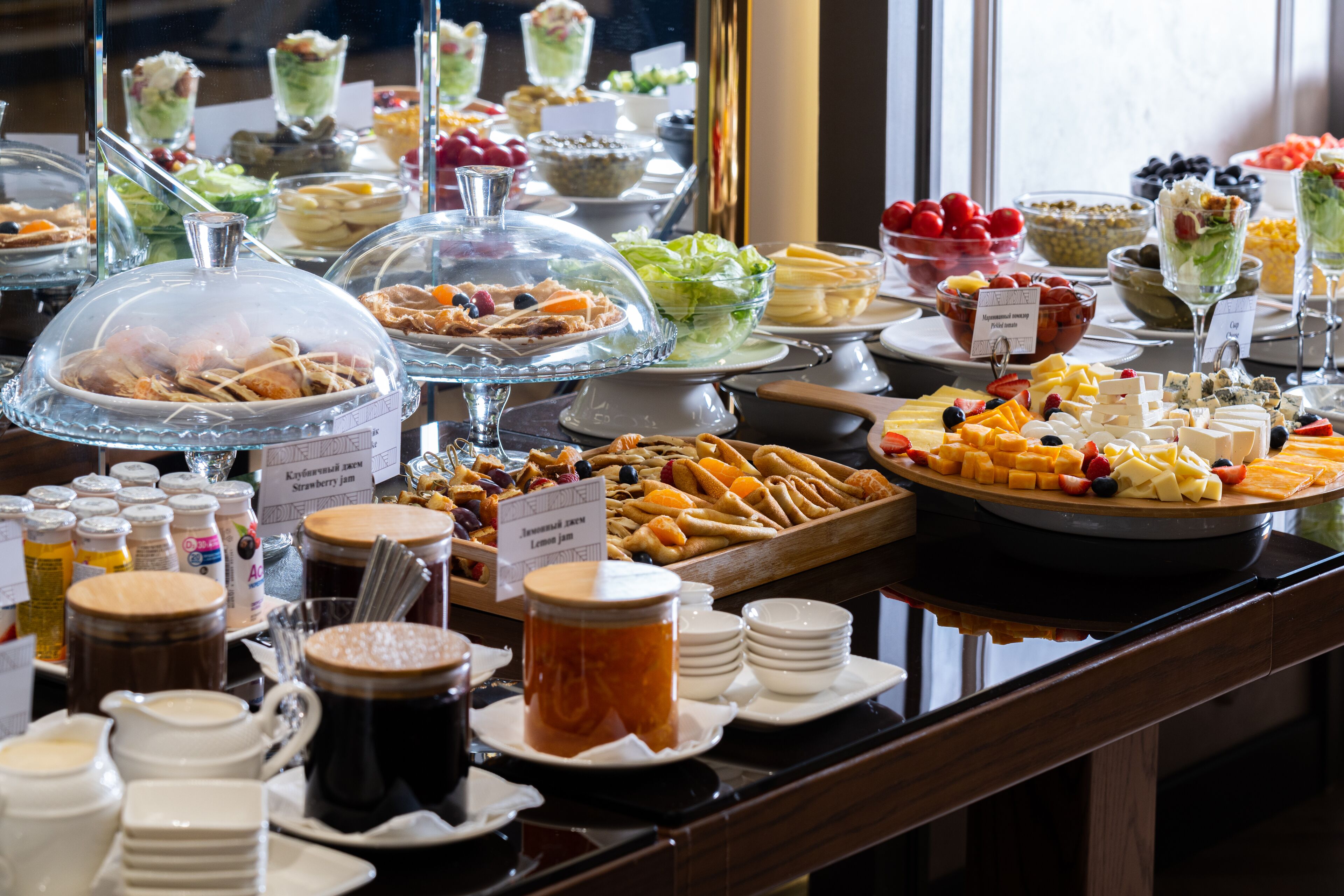 A buffet with various food items and beverages.