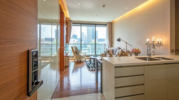 A modern kitchen with a large window, a dining area, and a view of the city skyline.