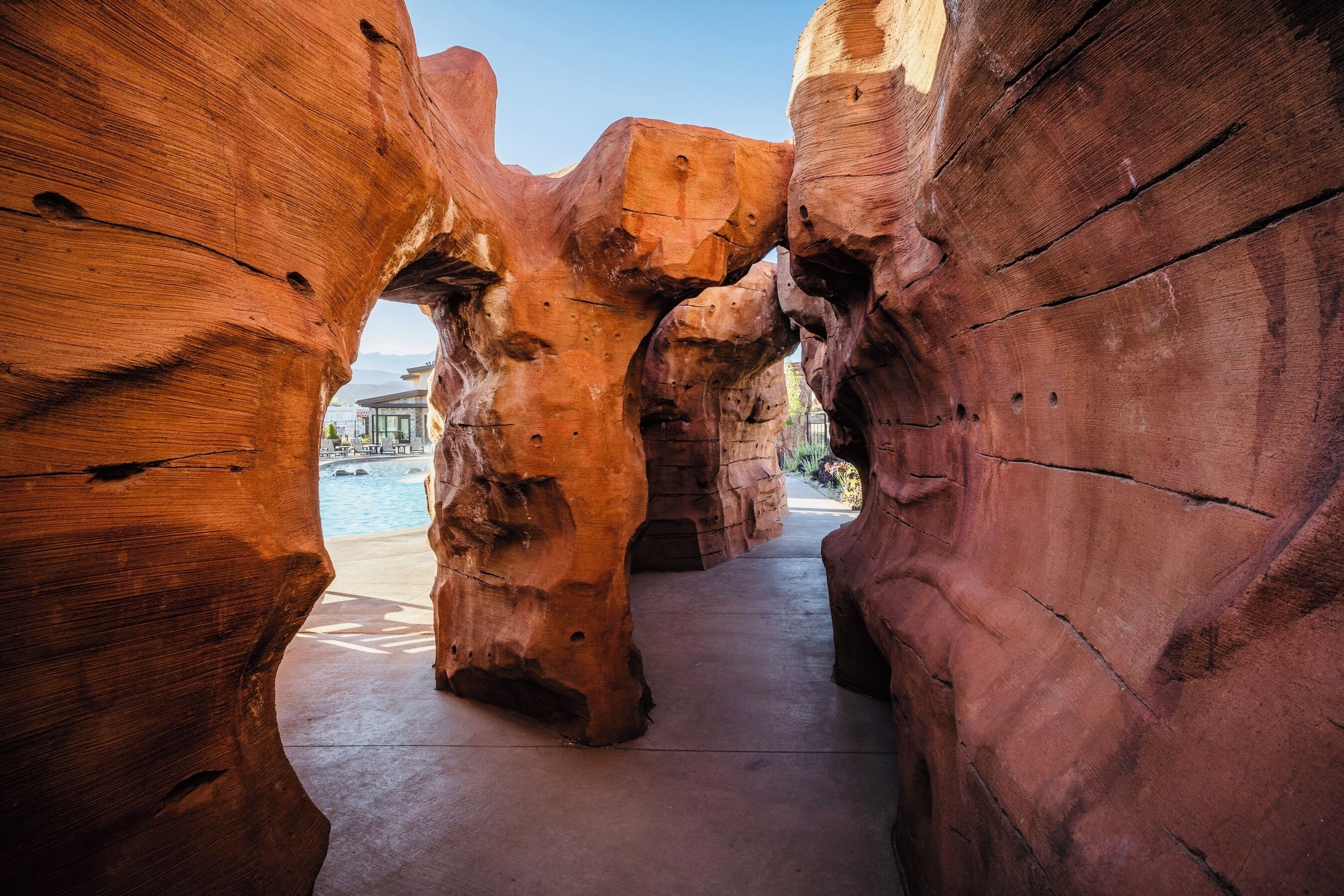 A rock formation with a clear pathway leading through it.
