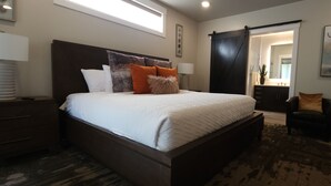 A bedroom with a large bed, a dark wooden headboard, and a sliding door closet. - SageCreek E7 "BalancedRock Retreat" - Amazing Pool (Moab)