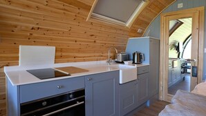 A compact kitchen with a built-in oven, a sink, and a small countertop.
