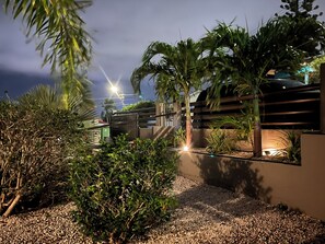 A well-maintained garden with various plants and a gravel pathway. - Family house with private pool (Willemstad)