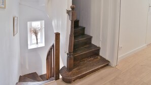 A wooden staircase with a small window at the top.
