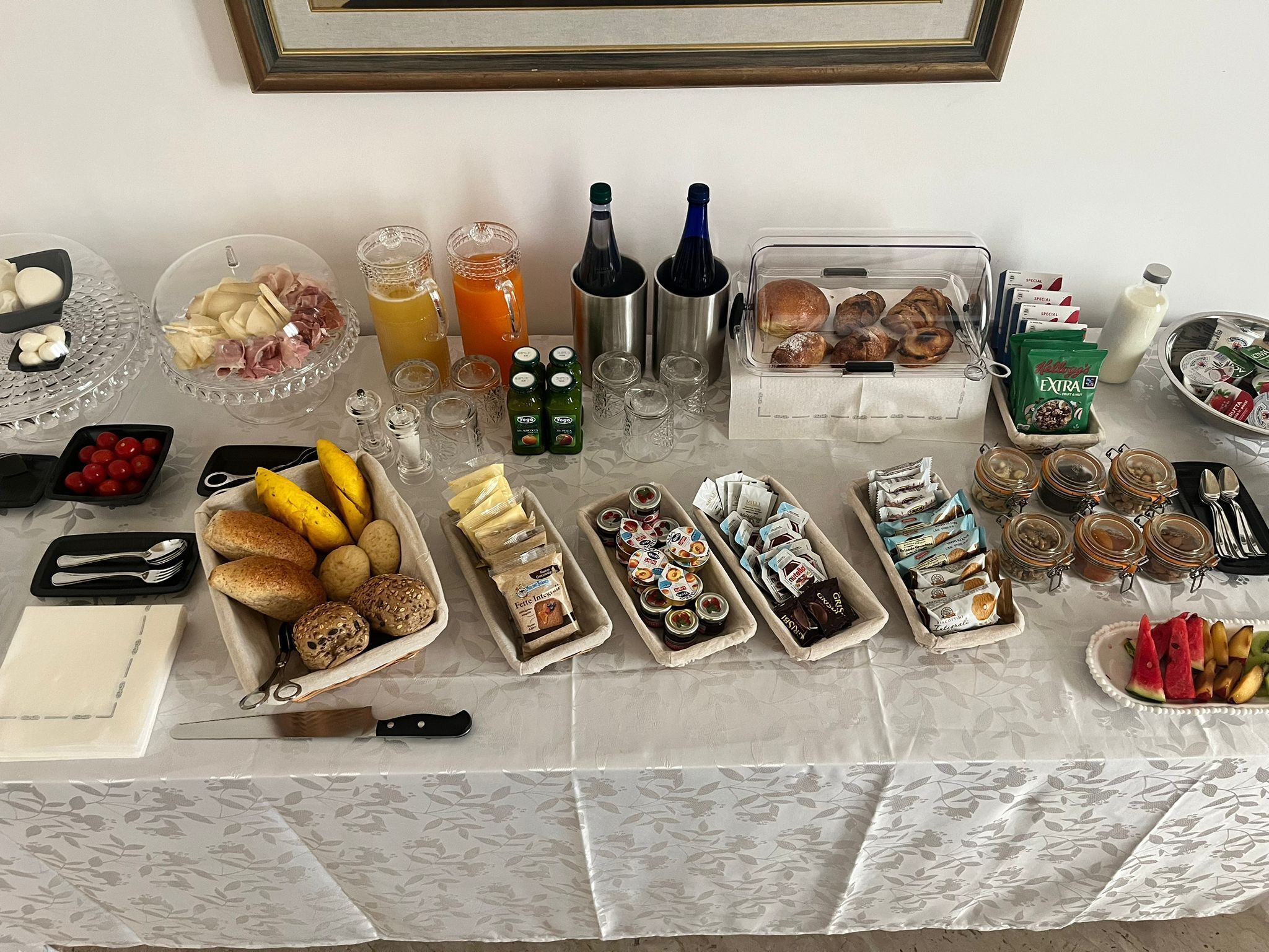 A table with various food items, condiments, and beverages.