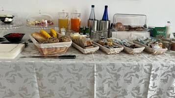 A breakfast buffet with various food items and beverages.