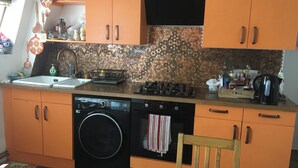 A compact kitchen with a dishwasher, stove, and sink. - Beautiful 2-bed Apartment in Dagenham (Dagenham)