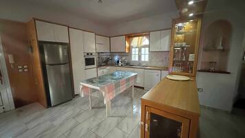 Villa | Private kitchen | Fridge, microwave, oven, stovetop