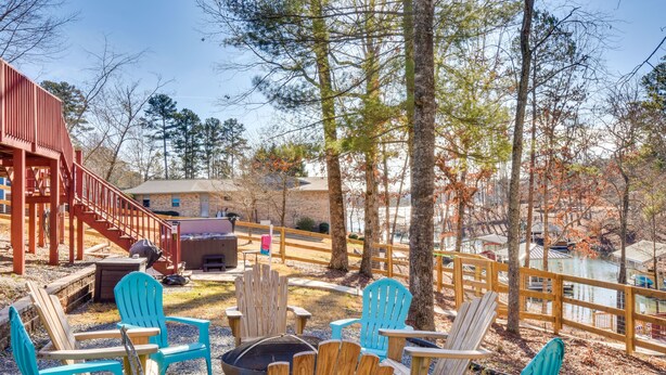 A deck with Adirondack chairs, a fire pit, and a wooden staircase leading to a building. - South Carolina Retreat w/ Fireplace & Lake Access! (Seneca)