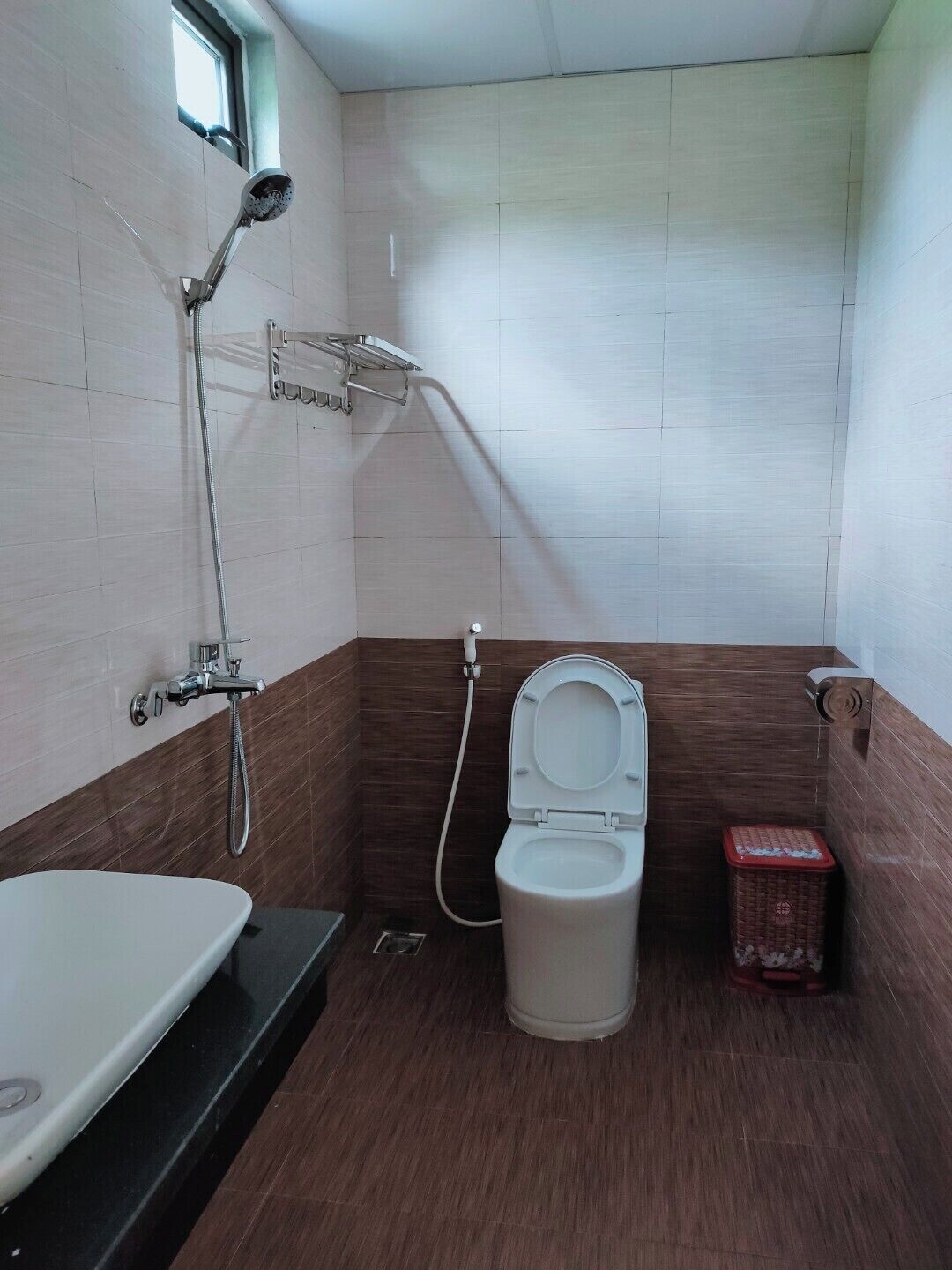 A compact bathroom with a shower, toilet, and bathtub.